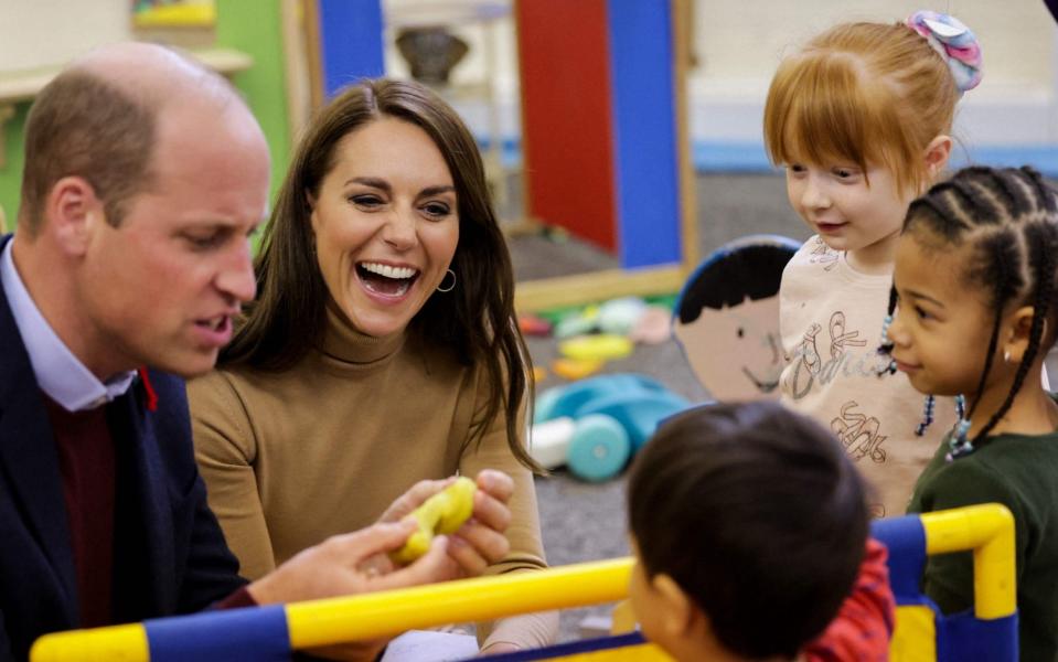 Prince of Wales and Britain's Catherine, Princess of Wales play with Modelling Dough with children in the Nursery at The Rainbow Centre