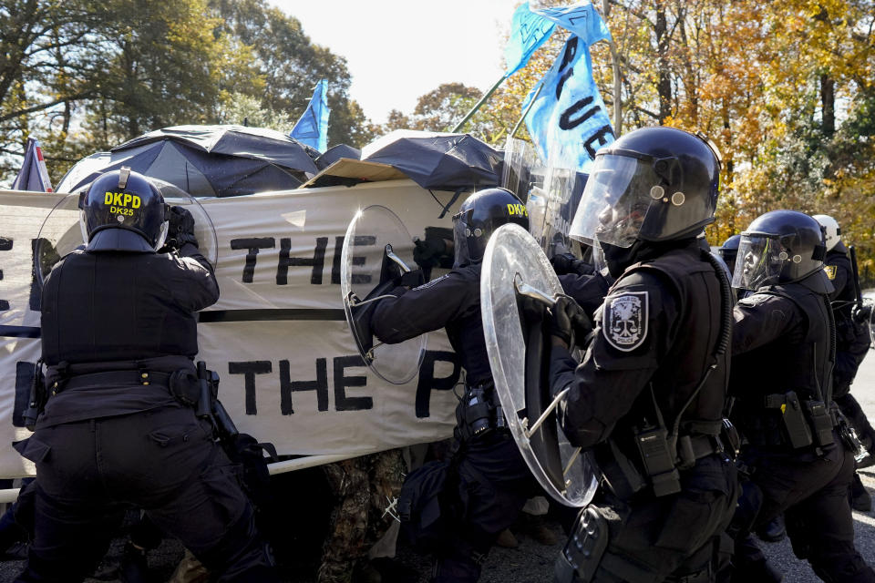 Protesters drive into a police line during a demonstration in opposition to a new police training center, Monday, Nov. 13, 2023, in Atlanta. (AP Photo/Mike Stewart)