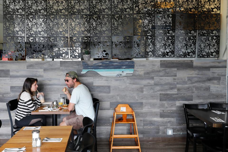 Kendra Oliveira and Chris Wynn enjoy breakfast at the newly opened What's Cookin on Acushnet Avenue in New Bedford.