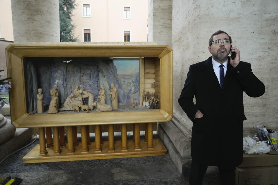 Ukraine's ambassador to the Vatican, Andrii Yurash, uses his phone prior to the start an interview with the Associated Press at the Vatican, Friday, Dec. 2, 2022. Yurash confirmed that both Ukraine's consulate in Naples and its embassy to Italy received letters, with the one in Naples containing fish eyes. In addition, Yurash said the entrance to his Rome residence was vandalized with what he believed was animal feces on Thursday afternoon. (AP Photo/Gregorio Borgia)