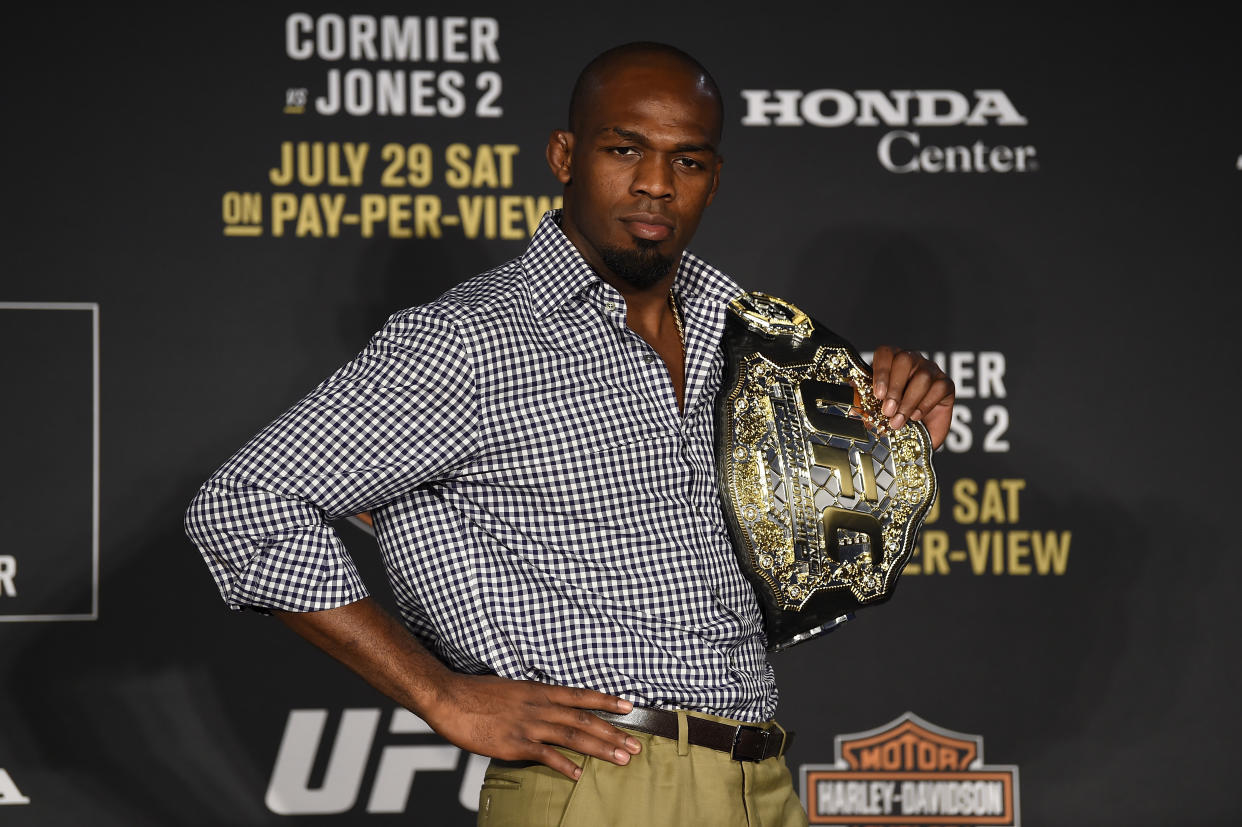 Jon Jones, shown holding the UFC’s light heavyweight title he won on July 29, 2017, by knocking out Daniel Cormier, was vindicated by an arbitrator Wednesday in his anti-doping case and can return to competition on Oct. 28. (Getty Images)