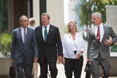 Wilmington Attorney Michael Kelly (far right) walks alongside clients in the Wilmington Trust case in 2017.