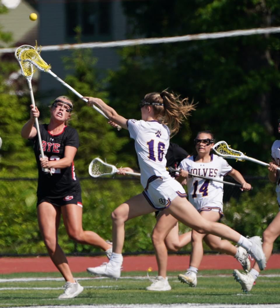 John Jay-Cross River's Shannon Nolan (16) works to try to block a pass from Rye's Lilly Whaling (22) during the girls lacrosse Section 1 Class C championship game at Nyack High School in Nyack on Friday, May 26, 2023.. Nolan is now playing for Lehigh University but Whaling, who gained all-American honors for Rye last spring, is back with the Garnets.