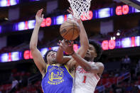 Golden State Warriors forward Trayce Jackson-Davis (32) and Houston Rockets forward Amen Thompson (1) battle for a rebound during the first half of an NBA basketball game Thursday, April 4, 2024, in Houston. (AP Photo/Michael Wyke)