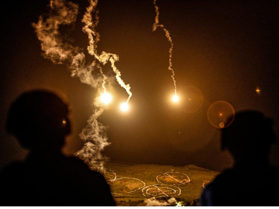 Taiwanese soldiers stand guard as flares are fired during a Taiwanese military shooting exercise, after Beijing stepped up its military exercises near Taiwan, in Pingtung, Taiwan, September 6, 2022.