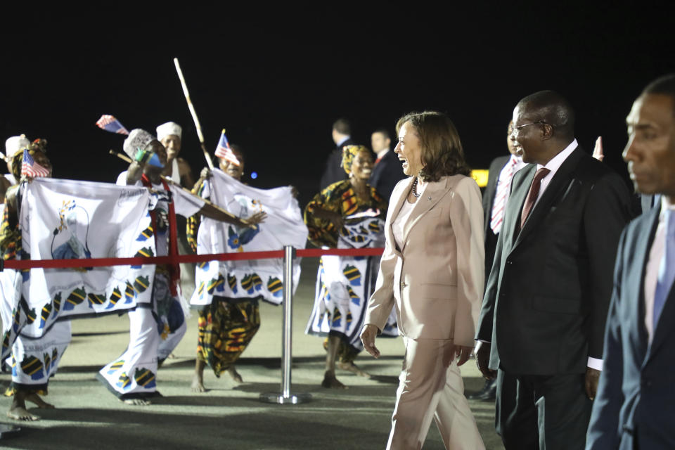 U.S. Vice President Kamala Harris, third right, with her husband Douglas Emhoff, not in photo, is welcomed by Tanzania's Vice President Philip Mpango, second right, on their arrival at Julius Nyerere International Airport in Dar es Salaam Wednesday, March 29, 2023. (Ericky Boniphace/Pool Photo via AP)