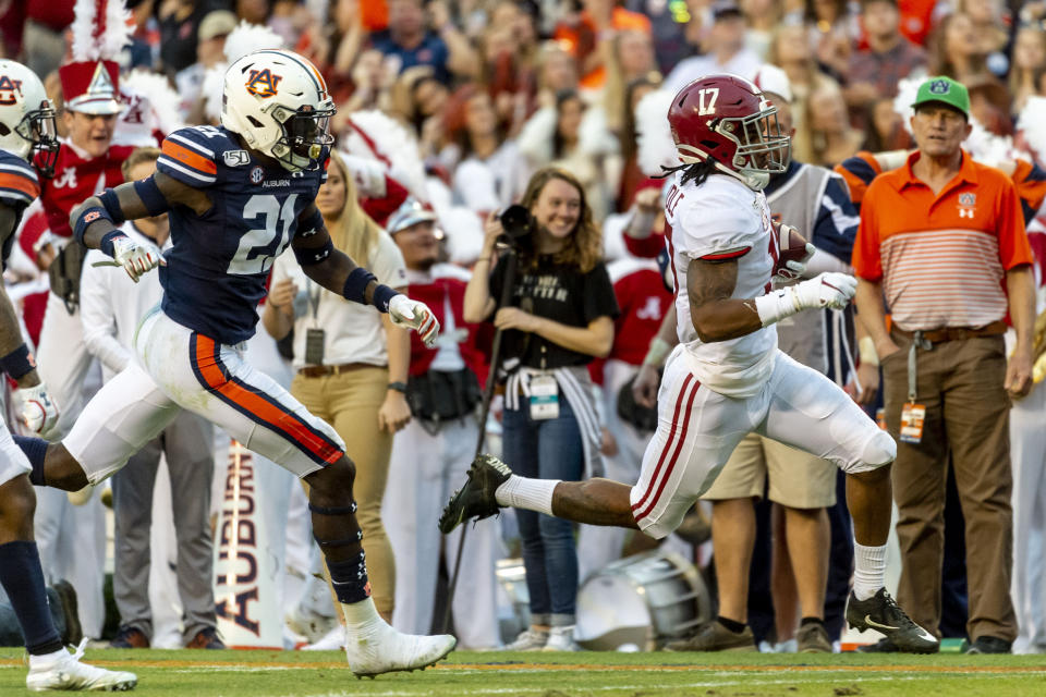 Alabama wide receiver Jaylen Waddle (17) runs past Auburn defensive back Smoke Monday (21) for a touchdown reception during the first half of an NCAA college football game, Saturday, Nov. 30, 2019, in Auburn, Ala. (AP Photo/Vasha Hunt)