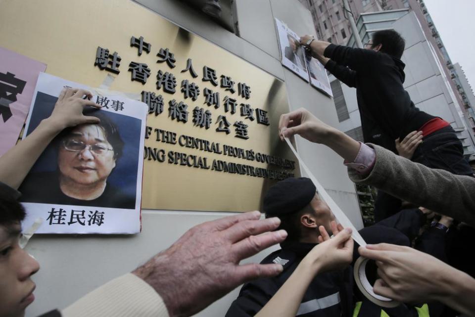 Protesters put up images of missing booksellers, one of which shows Gui Minhai, during a demonstration in Hong Kong.