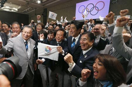 Prime Minister Shinzo Abe of Japan celebrates with members of the Tokyo bid committee as Jacques Rogge President of the International Olympic Committee announces Tokyo as the city to host the 2020 Summer Olympic Game during a ceremony in Buenos Aires