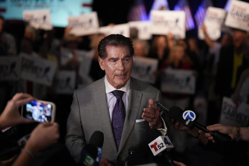 Republican U.S. Senate candidate Steve Garvey talks to reporters in front of supporters, Tuesday, March 5, 2024, in Palm Desert, Calif. (AP Photo/Gregory Bull)