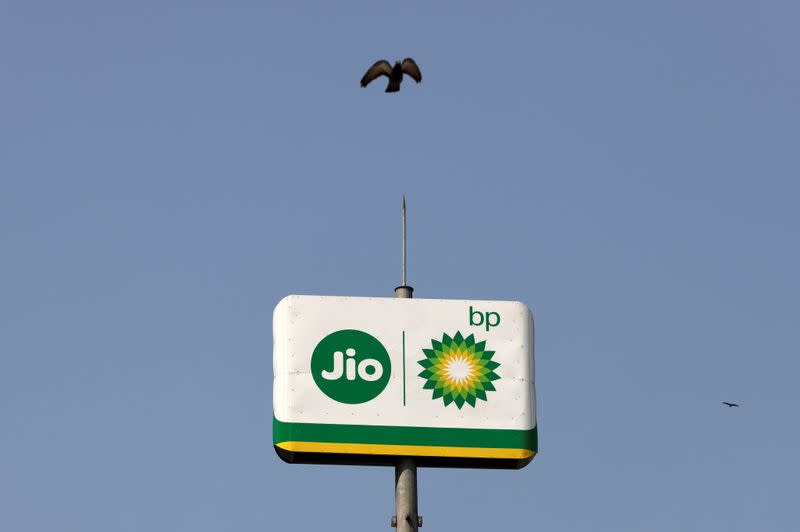 Bird flies over the logo of Jio-bp outside a fuel station in Navi Mumbai