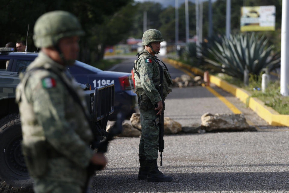 Soldiers forming part of the National Guard man an immigration checkpoint heading north out of Comitan, Chiapas state, Mexico, Sunday, June 16, 2019. Mexican President Andrés Manuel López Obrador said Saturday his country must help Central Americans fleeing poverty and violence, even as it increases security and revisions to deter migrants from passing through Mexico on route to the U.S. AP Photo/Rebecca Blackwell)