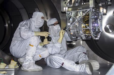 Laser Interferometer Gravitational-wave Observatory (LIGO) technicians perform a Large optic inspection in this undated photo released by Caltech/MIT/LIGO Laboratory on February 8, 2016. REUTERS/Caltech/MIT/LIGO Laboratory/Handout via Reuters/Files