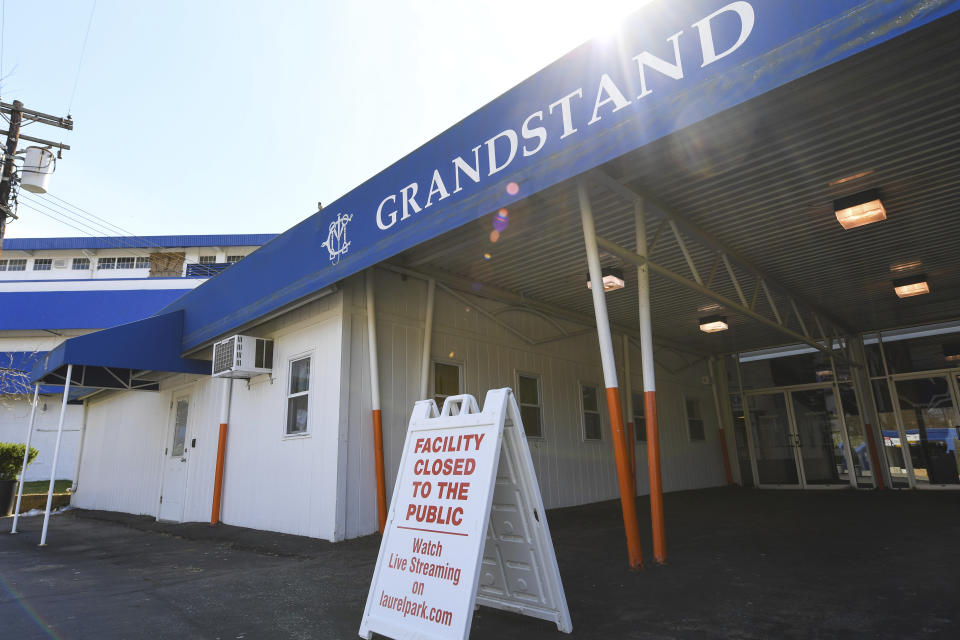 A closed to the public sign sits outside of the Grandstand at Laurel Park Race Track, Saturday, March 14, 2020, in Laurel, Md. The track is closed to the public due the coronavirus outbreak. (AP Photo/Terrance Williams)
