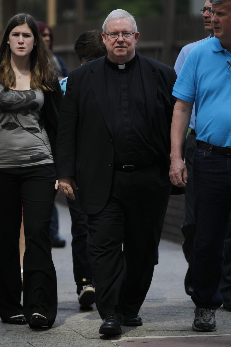 FILE—This file photo from June 19, 2012, shows Monsignor William Lynn, center as he walks to the Criminal Justice Center, in Philadelphia. Lynn was charged with child endangerment, for allegedly keeping co-defendants former priest Edward V. Avery and the Rev. James J. Brennan, and other accused predators, in ministry. Two years ago, U.S. attorney William McSwain in Philadelphia joined the long line of ambitious prosecutors investigating the Roman Catholic church's handling of priest-abuse complaints. The Justice Department had never brought a conspiracy case against the church. McSwain sent subpoenas to dioceses across Pennsylvania asking them to turn over their files and submit to grand jury testimony if asked. The dioceses pledged to comply. But as McSwain's tenure nears its end as President-elect Joe Biden takes office next month, there's no sign that any sweeping church indictment is afoot. (AP Photo/Matt Rourke, File)