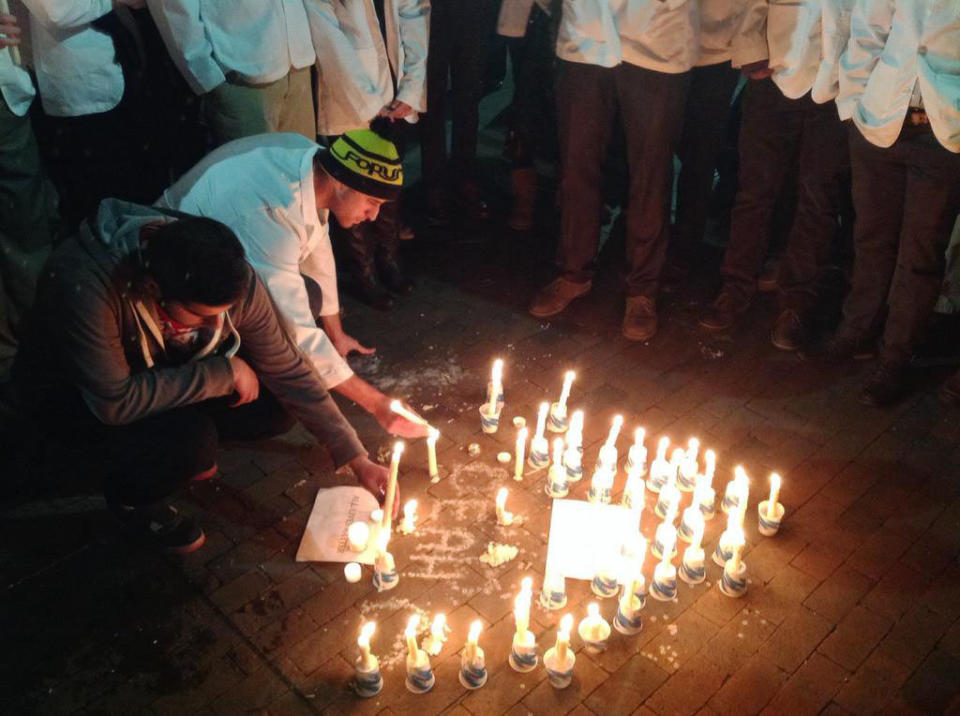 UNC dental students light candles for victims on Wednesday Feb. 11, 2015. 