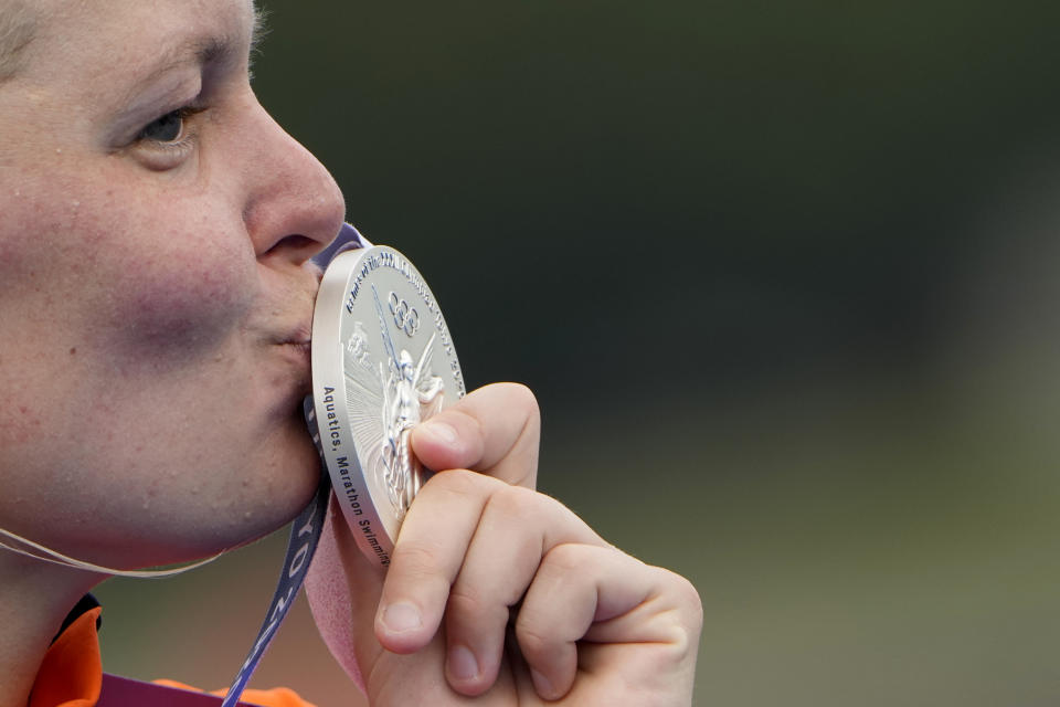 Sharon van Rouwendaal, of the Netherlands, kisses her silver medal during the victory ceremony for the women's marathon swimming event at the 2020 Summer Olympics, Wednesday, Aug. 4, 2021, in Tokyo. (AP Photo/David Goldman)