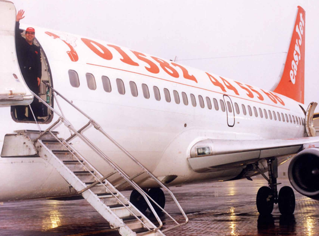 First mover: Stelios Haji-Ioannou and the maiden flight of easyJet from Luton to Glasgow in November 1995. Air Passenger Duty came in the previous year.   (Tony Anderson)