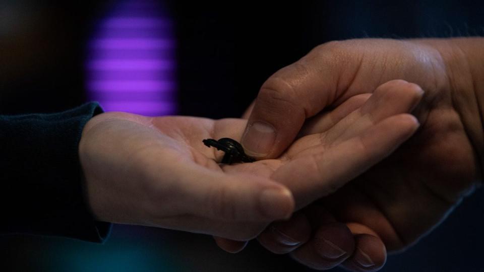 Daniel Lowe presses the eagle, globe and anchor into the palm of his son, Jack Lowe, during a ceremony in his home in Flowery Branch, Georgia, on Nov. 1. (Staff Sgt. Warren Smith/Marine Corps)