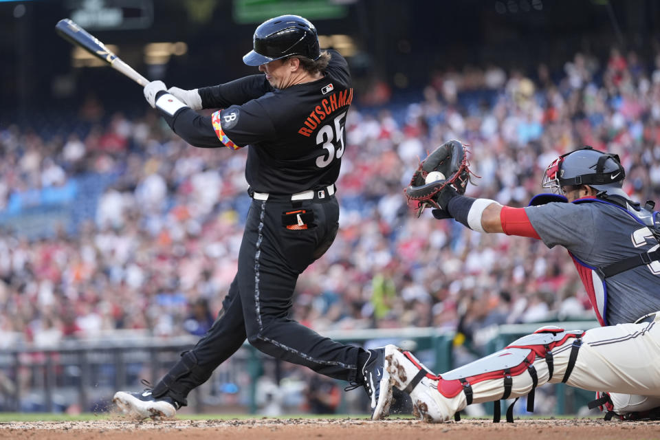 Washington Nationals catcher Keibert Ruiz (20) catches the ball as Baltimore Orioles catcher Adley Rutschman (35) swings and misses during the third inning of a baseball game at Nationals Park in Washington, Tuesday, May 7, 2024. (AP Photo/Susan Walsh)