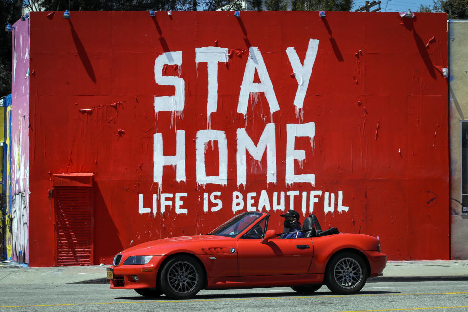 A mural reads "Stay Home, Life is Beautiful' Tuesday, April 14, 2020, in Los Angeles. (AP Photo/Marcio Jose Sanchez)