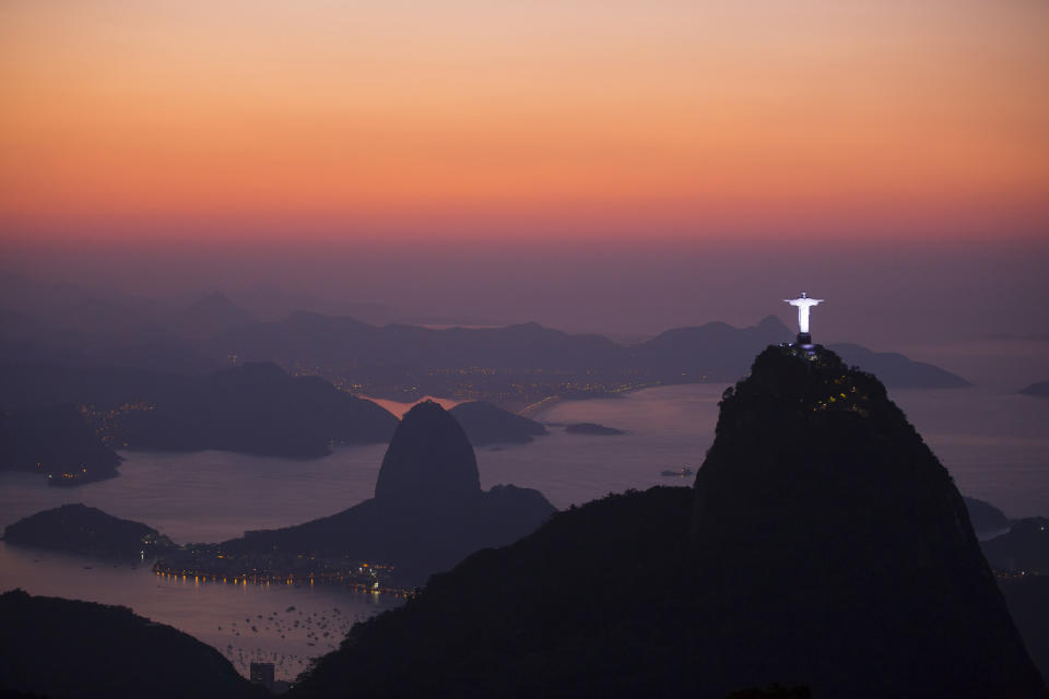 This Sept. 6, 2012 photo shows the Christ the Redeemer statue, located on the top of Corcovado Mountain and the Sugar Loaf Mountain, are seen from the Parque Nacional da Tijuca, or Tijuca national park in Rio de Janeiro, Brazil. This nearly 10,000-square-acre expanse of forest embedded in Rio de Janeiro is what allows this densely populated city to breathe. There are trails of various lengths and levels of difficulty carved through the forest, leading up to peaks with stunning of the city below. (AP Photo/Felipe Dana)