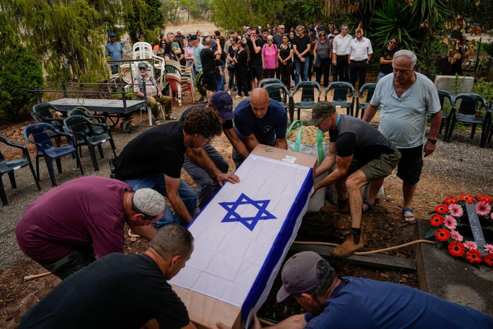 Nadav’s brother Roi Popplewell was buried at kibbutz Yagur near Haifa, on 27 October (AP Photo/Ariel Schalit)