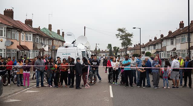 Members of the public observe the scene near a property in Edmonton where a woman is thought to have been beheaded. Photo: Getty Images