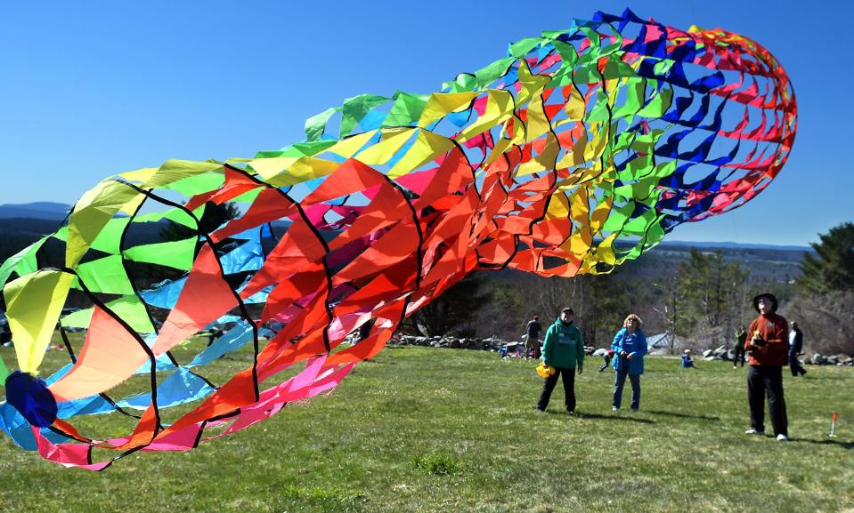 In a file photo, Glen Davison of Chelmsford sends his 20-foot-long rainbow wind sock into the sky as kite enthusiasts had a beautiful and windy Earth Day to fly during Fruitlands Museum's Earth Day Kite Festival in Harvard.