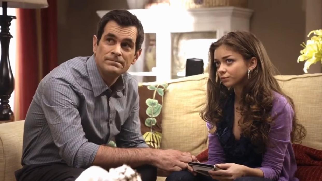  phil teaching haley how to work the remote on modern family. 