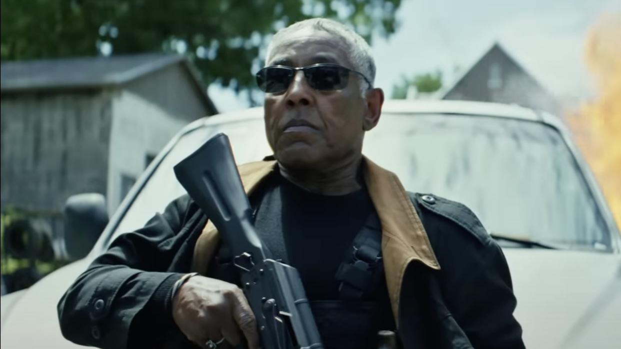  Giancarlo Esposito wearing sunglasses and holding rifle in Captain America: Brave New World. 