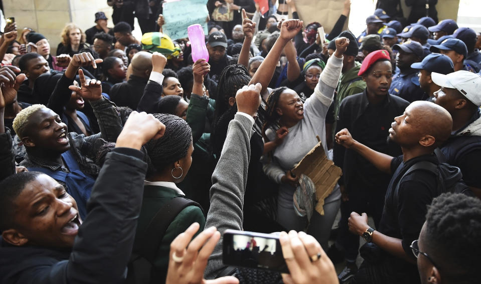 Protesters react after gaining entry to where the World Economic Forum on Africa is being held in Cape Town, South Africa, Wednesday, Sept. 4, 2019. The protesters are demanding that the government crack down on gender-based violence, following a week of brutal murders of young South African women that has shaken the nation. (AP Photo)