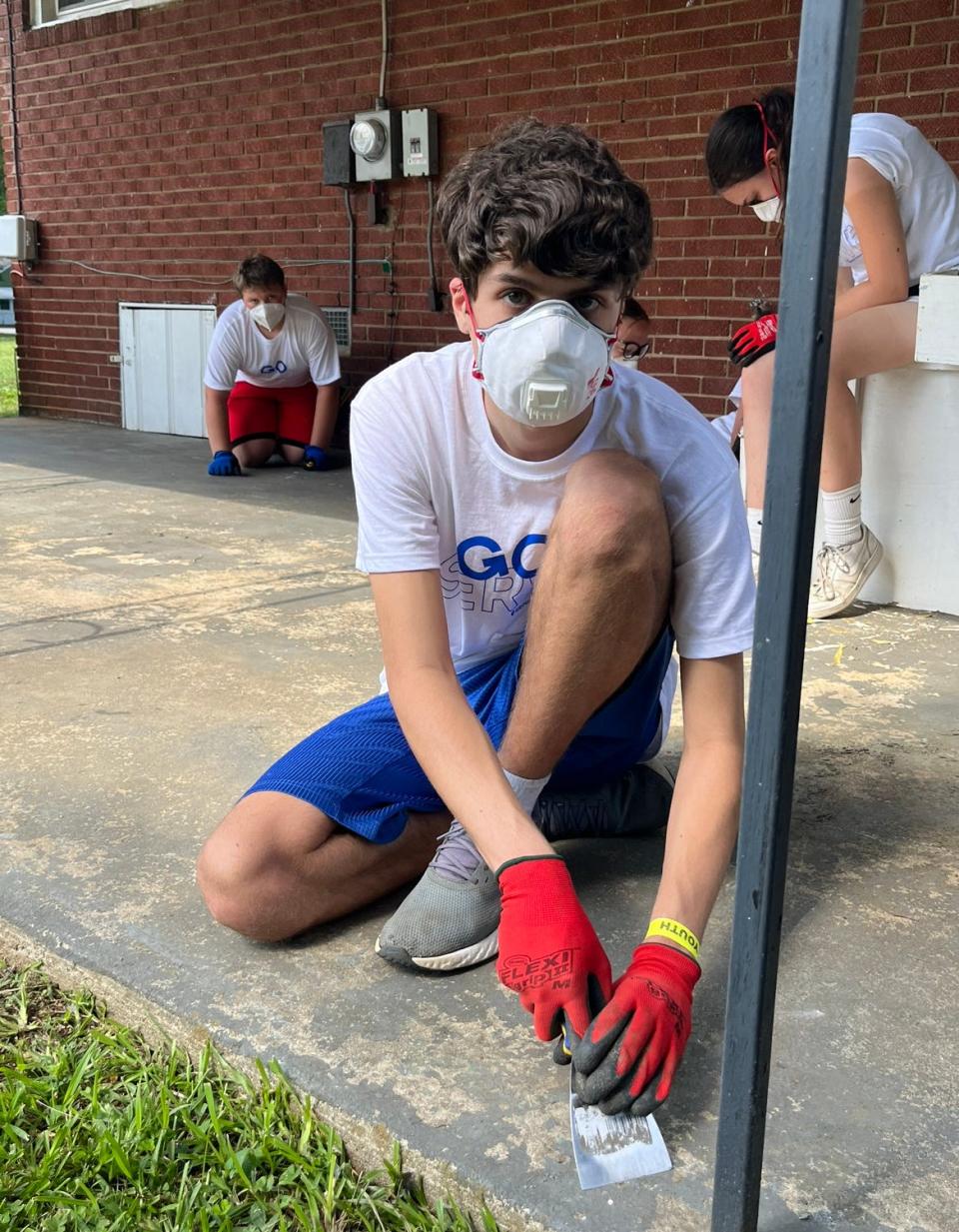 A student volunteer with Group Mission Trips works on the home of a Davidson County resident