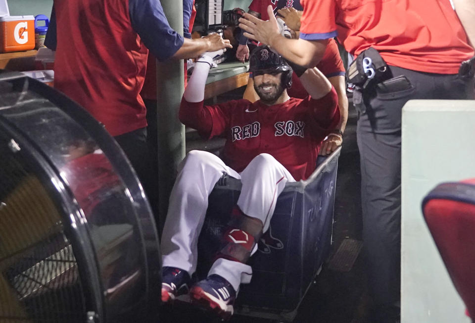 Boston Red Sox's J.D. Martinez celebrates his three-run home run with a ride in a laundry cart during the third inning of the team's baseball game against the Kansas City Royals at Fenway Park, Wednesday, June 30, 2021, in Boston. (AP Photo/Elise Amendola)