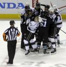 Referee Gord Dwyer (19) watches a fight between the San Jose Sharks and the Los Angeles Kings during the third period of Game 2 of an NHL hockey first-round playoff series Sunday, April 20, 2014, in San Jose, Calif. (AP Photo/Ben Margot)