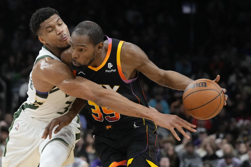 Phoenix Suns forward Kevin Durant, right, is fouled by Milwaukee Bucks forward Giannis Antetokounmpo during the second half of an NBA basketball game Tuesday, Feb. 6, 2024, in Phoenix. The Suns won 114-106. (AP Photo/Ross D. Franklin)