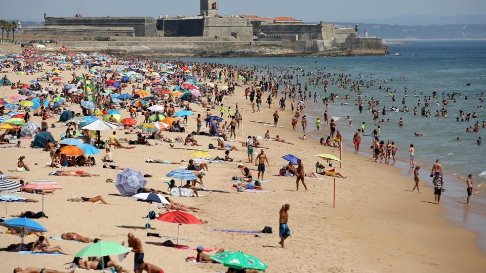 Strandbesucher an einem heißen Nachmittag am Strand Carcavelos.