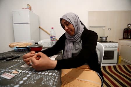 Olfa, 39, mother of Rahma who is the wife of Nurdine Chouchan, who was killed during a U.S. air strike in Libya, reacts during an interview with Reuters in Tunis, Tunisia April 14, 2016. REUTERS/Zohra Bensemra