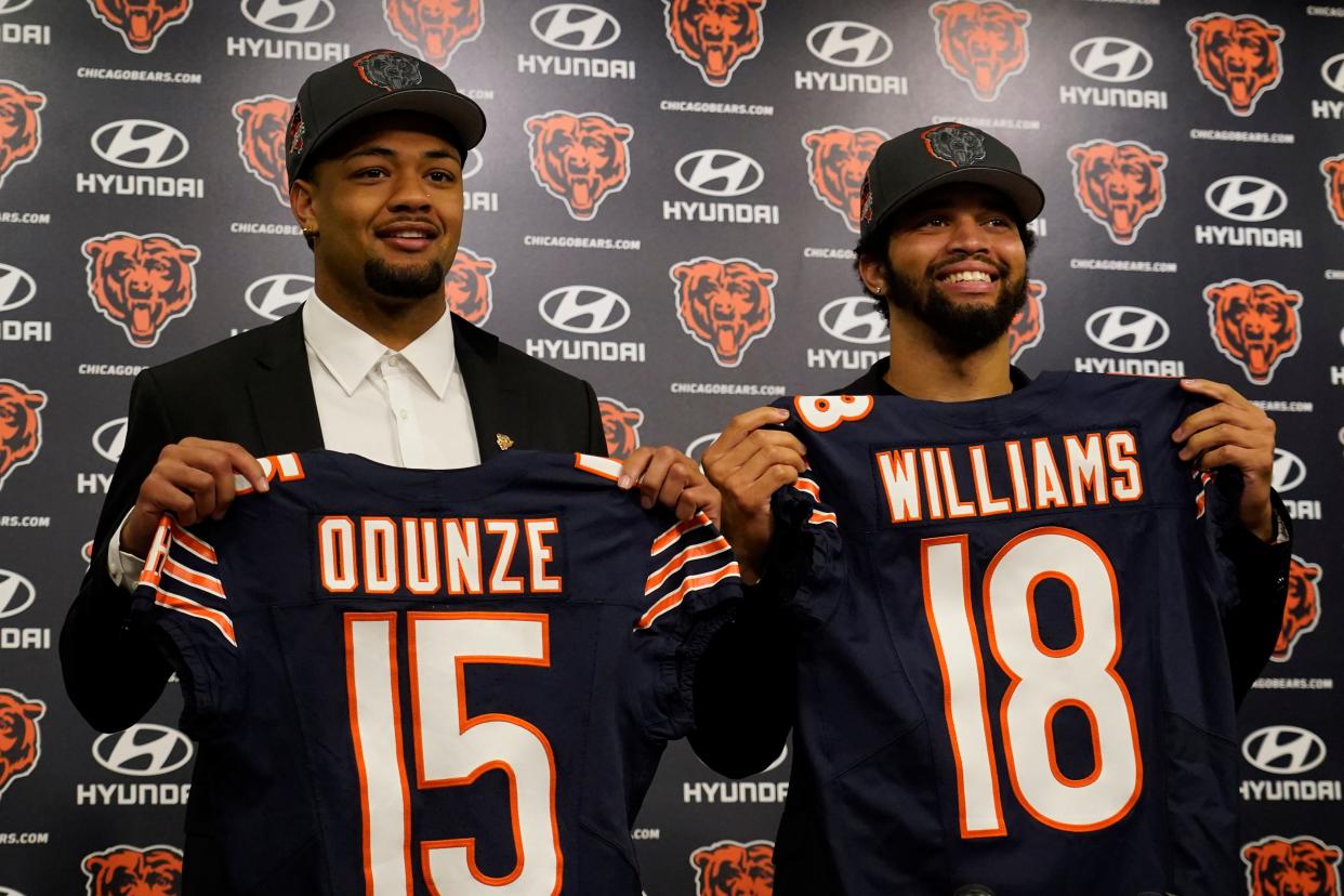 Chicago Bears first-round draft choices receiver Rome Odunze and quarterback Caleb Williams pose for photos at a news conference at Halas Hall, April 26, 2024 in Lake Forest, Illinois.