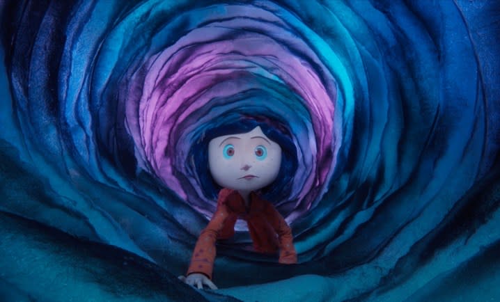 Coraline crawls through a dark tunnel.