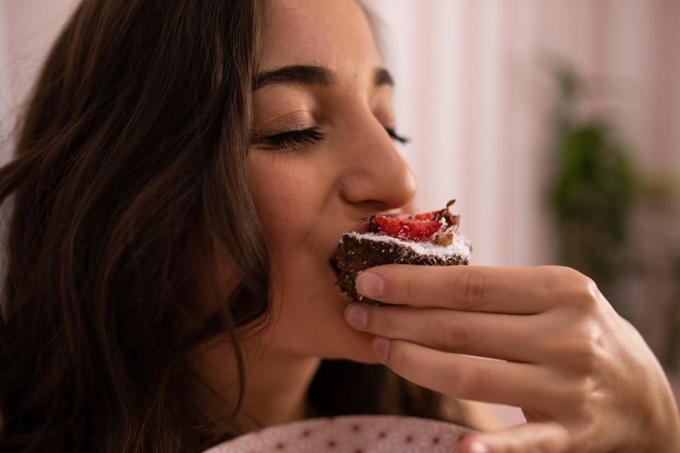 Woman eating brownie