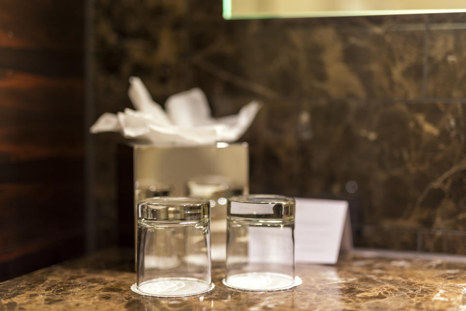 If your hotel room offers glasses instead of plastic cups, it's not a bad idea to clean them once more. They may not have been properly disinfected.&nbsp; (Photo: SammyVision via Getty Images)