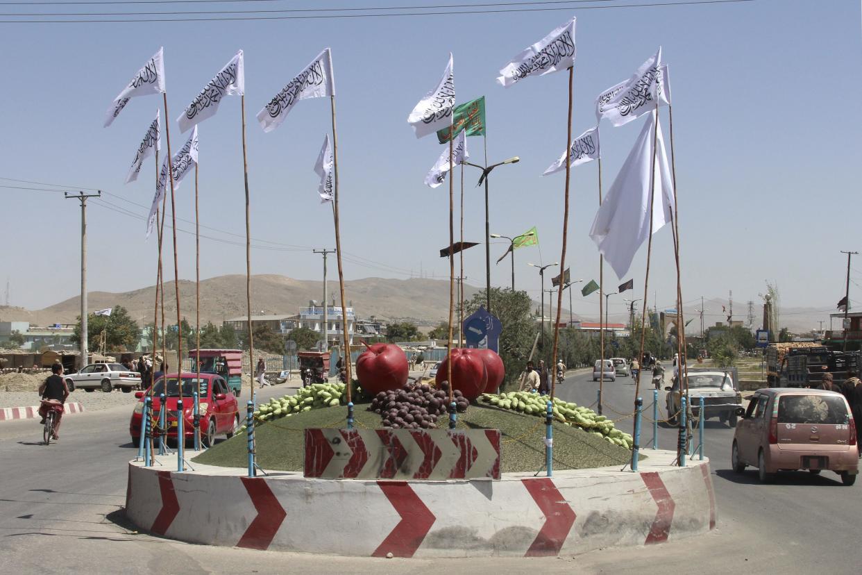 Taliban flags fly at a square in the city of Ghazni, southwest of Kabul, Afghanistan on Saturday, Aug. 14, 2021.