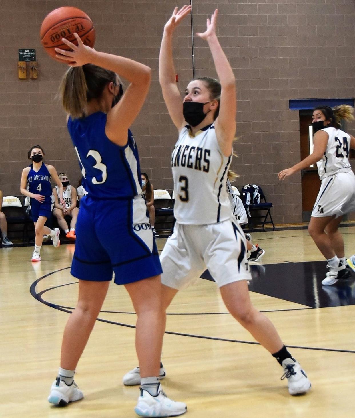 Traip Academy's Emme Hale defends Old Orchard Beach's Ganelle Ferguson during Friday's Class C South girls basketball in Kittery, Maine. Hale scored 15 points in a 51-39 loss.