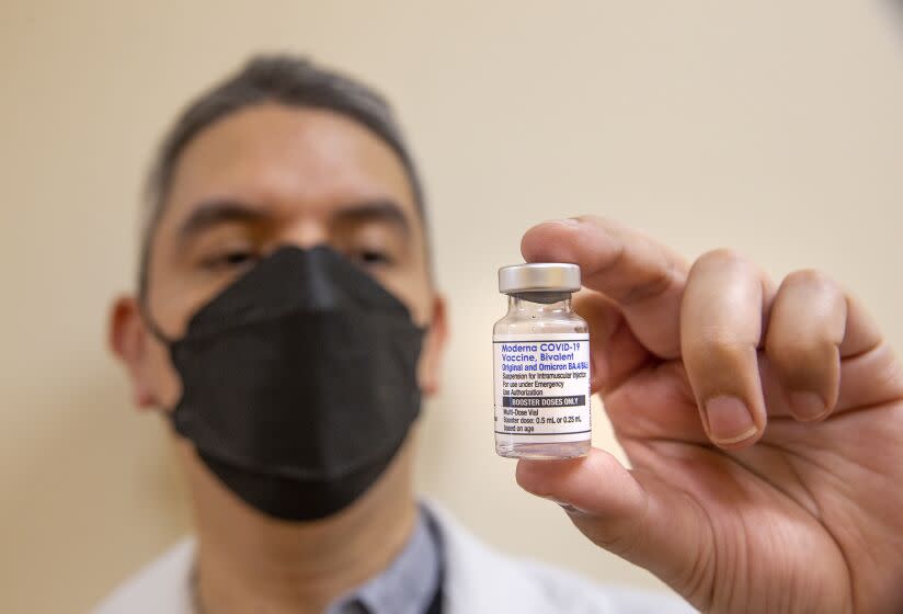 SOUTHGATE, CA-OCTOBER 6, 2022: Daniel Carrillo, a pharmacist at AltaMed in Southgate, holds a bottle containing booster doses of the Moderna COVID-19 vaccine, Bivalent, the updated booster from Moderna designed to help protect against multiple COVID-19 variants in a single shot. Earlier he administered this vaccine to Senator Alex Padilla. (Mel Melcon / Los Angeles Times)