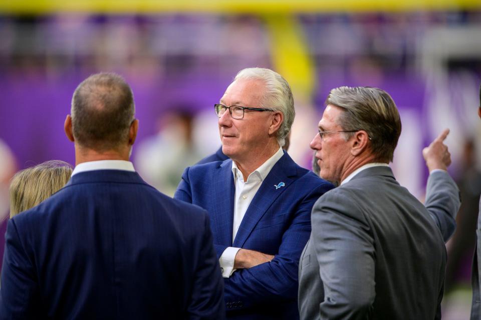 Detroit Lions team president/CEO Rod Wood, center, talks with Lions special assistant Chris Spielman, left, and Minnesota Vikings GM Rick Spielman, right, before the game at U.S. Bank Stadium, Oct. 10, 2021 in Minneapolis, Minn.