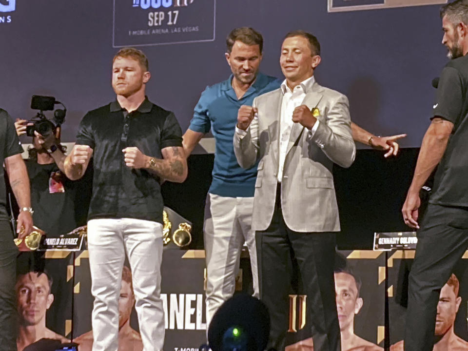 Saul "Canelo" Alvarez, left, poses with Gennadiy Gennadyevich Golovkin, known as "GGG," second from right, and promoter Eddie Hearn, middle, in Los Angeles on Friday, June 24, 2022. Alvarez and Golovkin are scheduled to fight in a super middleweight title boxing bout Sept. 17 in Las Vegas. (AP Photo/Greg Beacham)