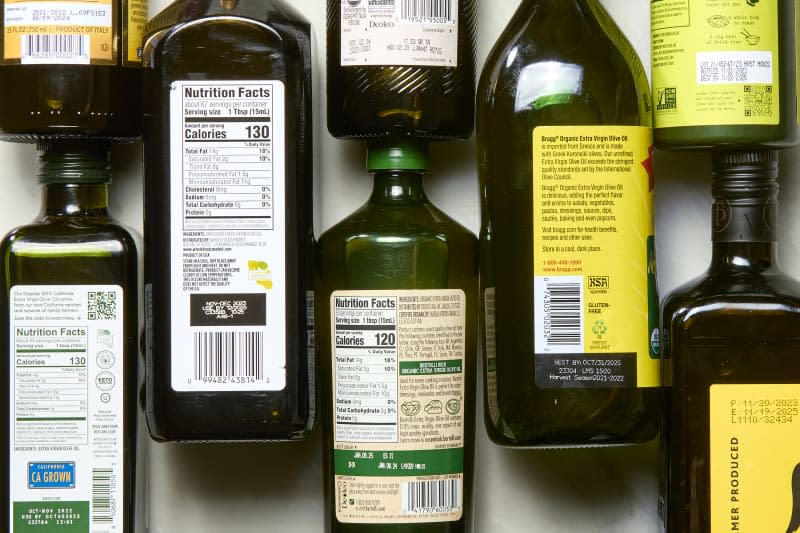 backs of a bunch of olive oil bottles