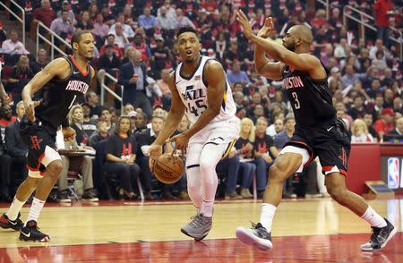 May 8, 2018; Houston, TX, USA; Utah Jazz guard Donovan Mitchell (45) is defended by Houston Rockets forward Trevor Ariza (1) and guard Chris Paul (3) in the first half in game five of the second round of the 2018 NBA Playoffs at Toyota Center. Mandatory Credit: Thomas B. Shea-USA TODAY Sports