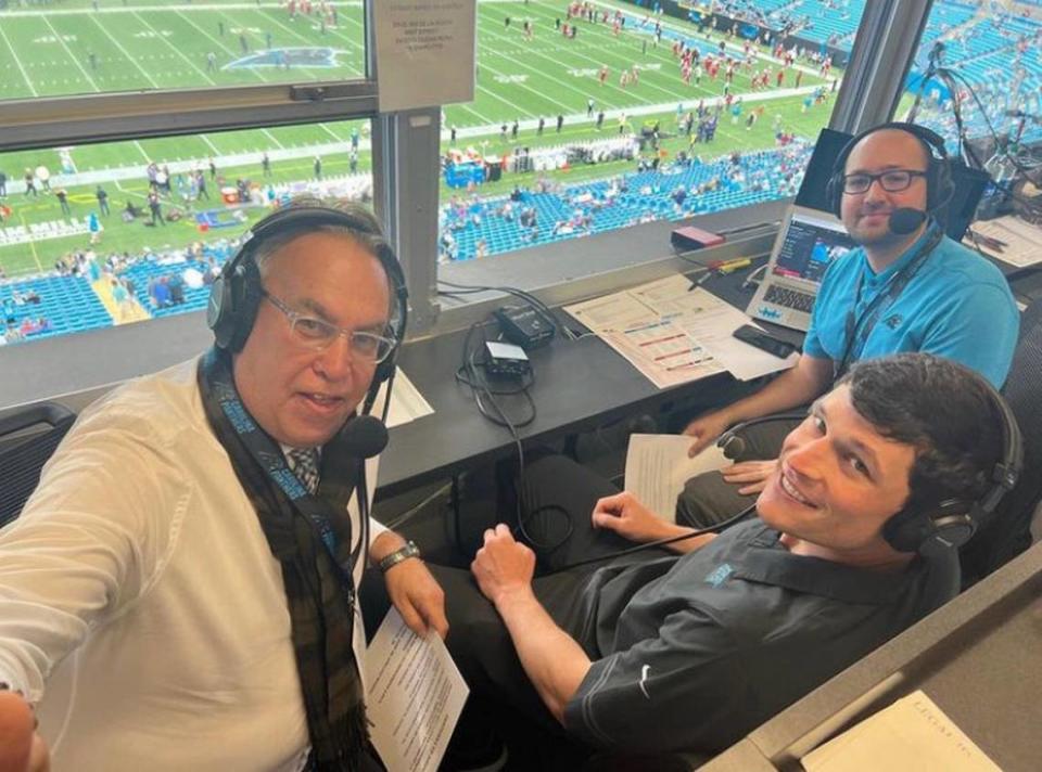 Voices of the Carolina Panthers Spanish Radio Network — Jaime Moreno, left, and Antonio Ramos, right — interview Panthers legend Luke Kuechley before a game during the 2022 season.